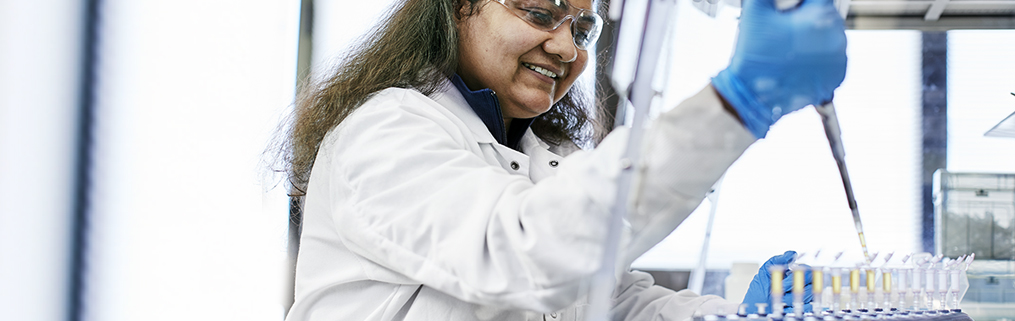 A young female scientist researching at her desk.