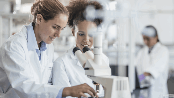 A young female scientist researching at her desk.
