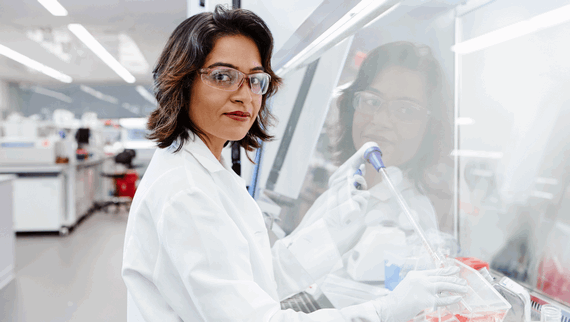 A female scientist conducting her research on a whiteboard.