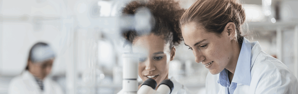 A young female scientist researching at her desk.