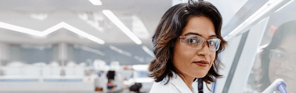 A young female scientist researching at her desk.