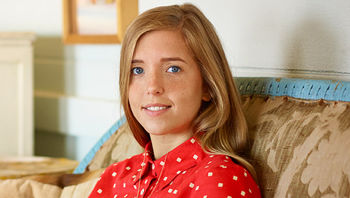An adolescent young woman sitting in her living room smiling. An adolescent young woman sitting in her living room smiling.