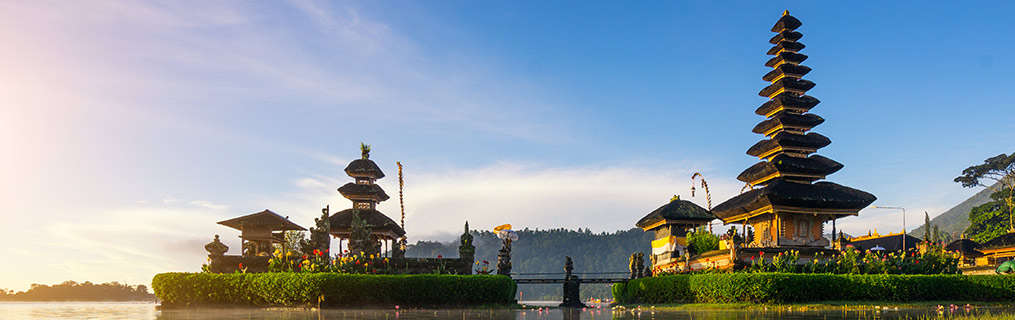 A traditional Indonesian temple and its surrounds at dusk.